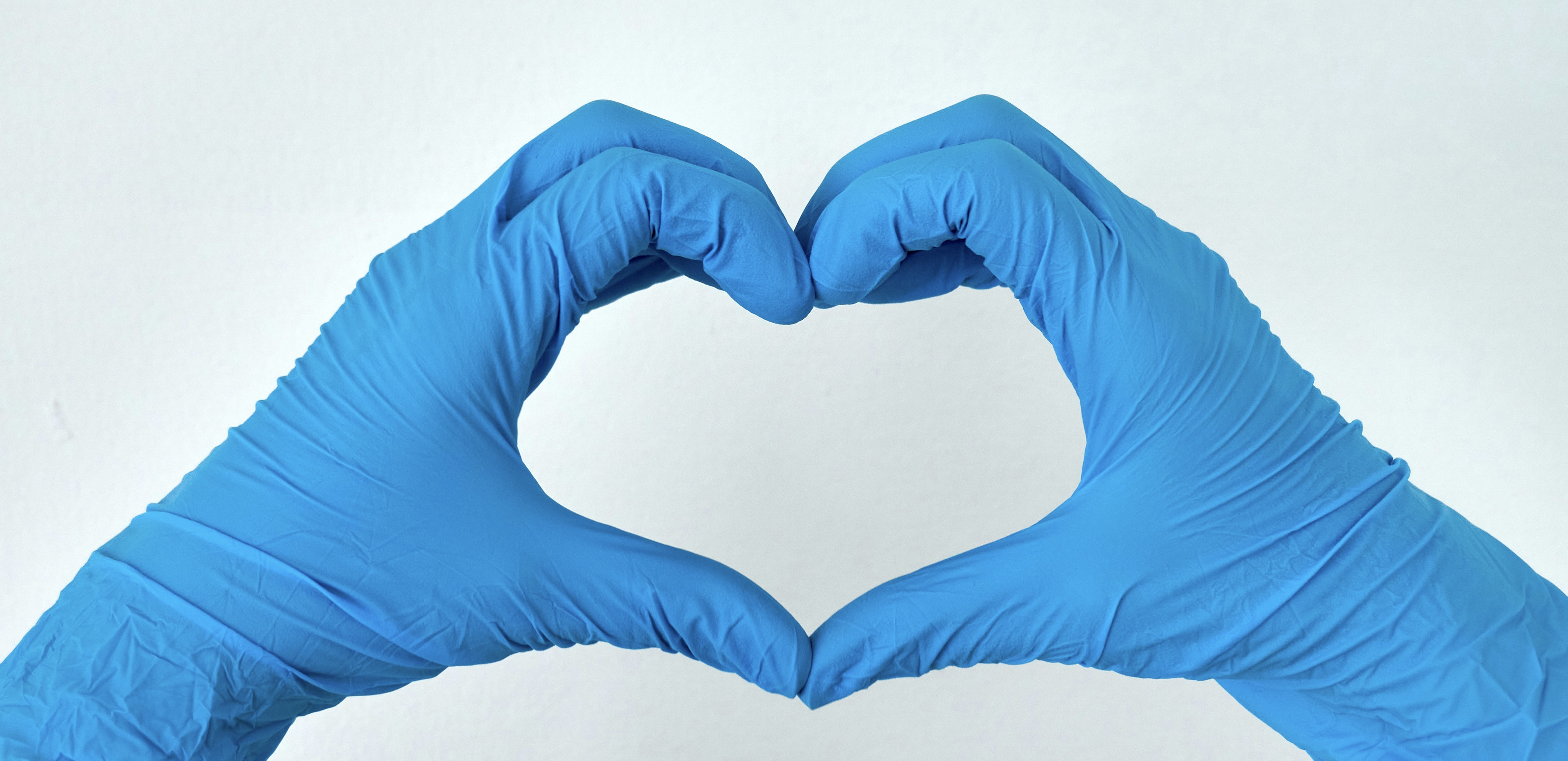 Banner image of someone making a heart with their hands in medical gloves